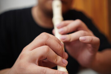 Obraz premium Asian man playing recorder flute, musical instrument
