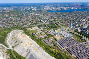 Aerial view on the movement of cars on the ring road. Top view of the city and car junctions