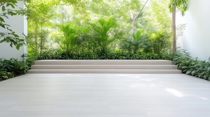 Tranquil indoor-outdoor patio space. Lush greenery surrounds a light-colored paved terrace