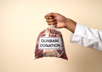 eid ul adha Mubarak - Qurbani Donation with Raw Meat Bag - Symbol of Eid al-Adha Charity and Sacrifice - hand holding a bag of meat
