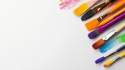 Fototapeta premium Variety of artistic paintbrushes with colorful swatches. Great for art, education, and creative project visuals.