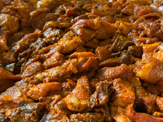 Chopped and seasoned pork meat prepared for grinding into sausages. Traditional homemade sausage making process in a rustic or farm kitchen.