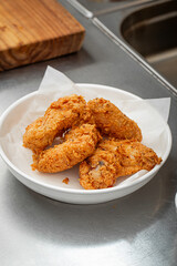 Portion of golden fried chicken in the cafe kitchen