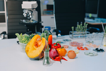 Team Asian scientists in a lab conducting food research using a microscope and lab equipment,...