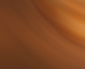 Abstract blurred background featuring a gradient of brown and orange colors with soft light effects