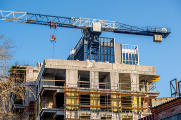 Scaffolding on the wall of a building under construction.