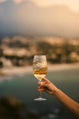 Shot of Person Holding Glass of White Wine