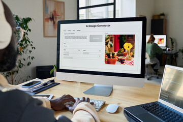 Screen of desktop computer with AI image generator standing on workplace of designer using or testing new product