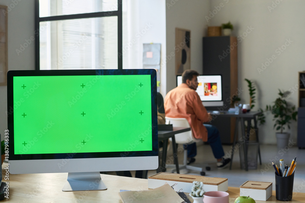 Poster Desktop computer with blank chromakey screen standing on workplace of software developer or programmer in modern office