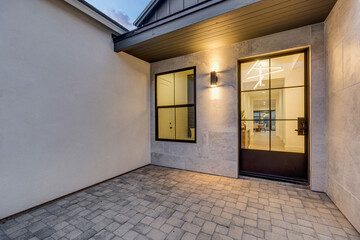 A beautiful patio that features a door and a window in a house