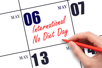 May 6. Hand writing text International No Diet Day on calendar date. Save the date.