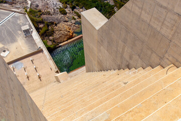 Steep stone staircase descends from the dam to the reservoir Wadi Dayqah. It is located in the...