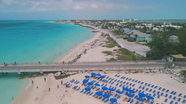 Aerial drone footage around Bimini Bahamas in the vicinity of the cruise terminal with beautiful white sand beaches and abandoned vacation houses with pools and dock.
