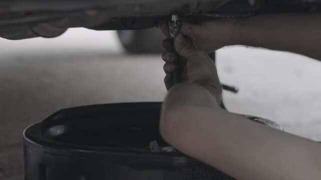Man Changing Transmission Oil
