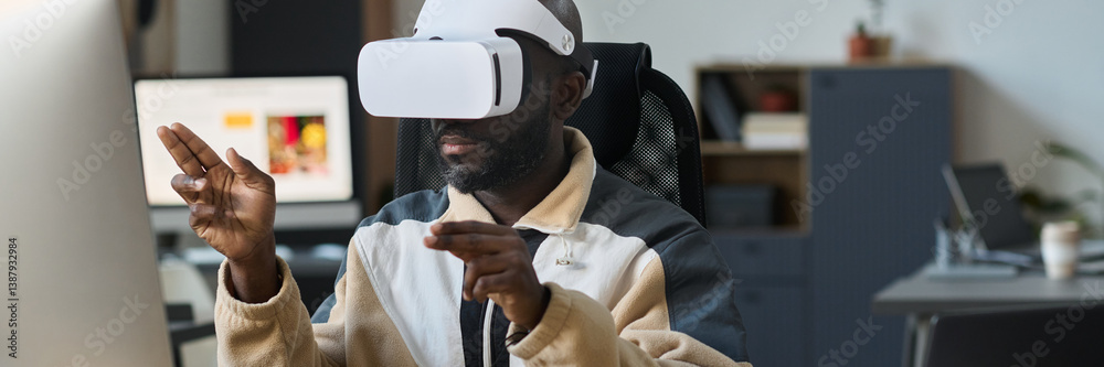 Fototapete header of young modern businessman in vr headset sitting in front of desktop computer and preparing 