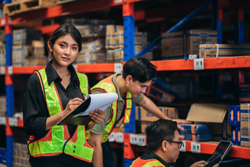 Warehouse worker working and checking the stock in the warehouse. .Factory manager using digital tablet check barcode in industry factory logistic.