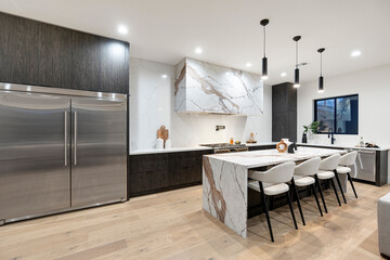 A kitchen with modern stainless steel appliances and a large island