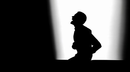 Silhouette of a person expressing emotion in a dramatic lighting setup during a performance or artistic presentation