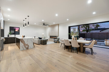 A spacious living and dining room featuring elegant hardwood floors