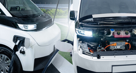 Charging electric vans. One van with open hood