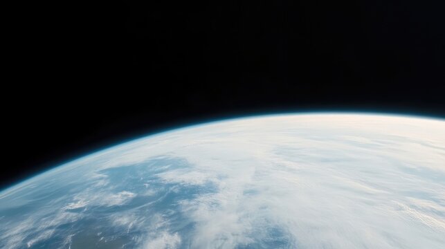 A high-resolution image shows Earth from space. The planets curvature is visible, with a mix of clouds and landmasses. The dark background emphasizes the planets fragility. Cool blues and whites dom