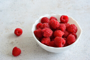 A bowl of fresh ripe red raspberries