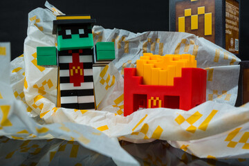 Fototapeta premium Bangkok, Thailand - April 6, 2025 : Zombie hamburglar and Minecraft fries helmet, Minecraft blind box from McDonald's collaborates.
