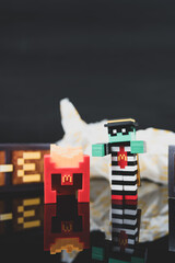 Fototapeta premium Bangkok, Thailand - April 6, 2025 : Zombie hamburglar and Minecraft fries helmet, Minecraft blind box from McDonald's collaborates