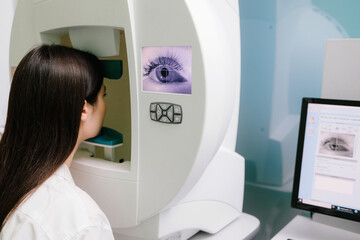 Perimetry eye test for early signs of glaucoma in women at an ophthalmology clinic, measuring full...