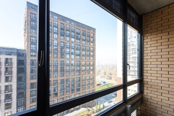 the balcony of an apartment on the upper floors of an apartment building