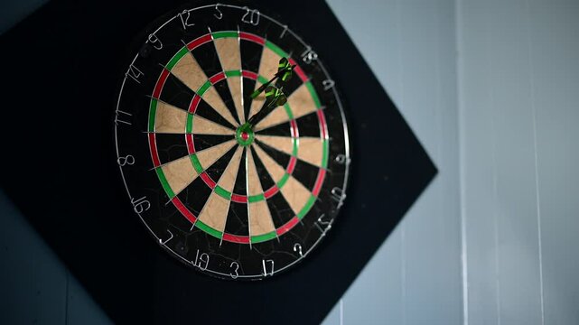 throwing darts selective focus video, close up on the dart board