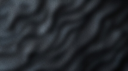 Abstract gradient texture of folded black fabric layers creating a rich and elegant depth in a soft minimal style