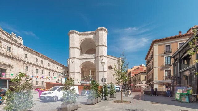 Panorama showing church of San Benito el Real timelapse, a historic Benedictine monastery in Valladolid, Spain. The Gothic-style facade stands tall under a blue sky, essence of medieval architecture.