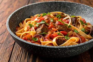 Fototapeta premium pasta dish fettuccine salted beef chunks tomato