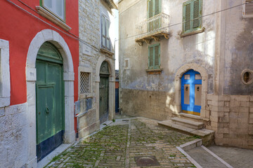 A narrow street among the old houses of Ripamolisani, a medieval village in Molise, Italy.