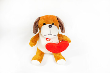 cute toy puppy with red heart on light background. friends day. pet care