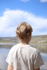 Fototapeta premium little boy looking at the sea