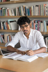 Higher education. Busy millennial man diligent student focused on learning at college university...