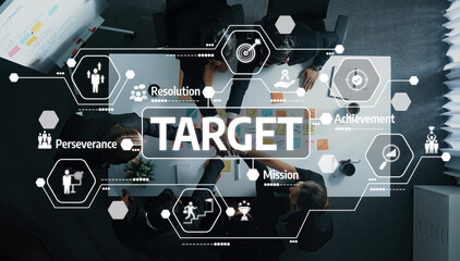 A modern office scene showing a collaborative team engaged in planning and strategizing for target achievement, enhanced with graphic icons illustrating key concepts. Amity