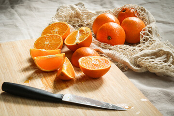 fresh oranges on a wooden cutting board 