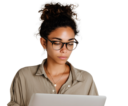 Focused woman wearing glasses and a casual shirt while using a laptop. She is looking down intently with her hair in a bun.