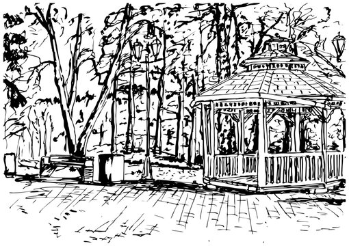 Wooden gazebo in the park against the background of trees
