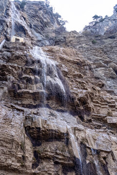 Low-water waterfall with cascades. Uchan Su Waterfall, spring, March, Crimean Peninsula. Yalta Mountain Reserve. Vertical