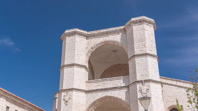 Church of San Benito el Real timelapse, a historic Benedictine monastery in Valladolid, Spain. The Gothic-style facade stands tall under a blue sky, capturing the essence of medieval architecture.