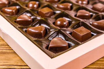 Heap of chocolate candies in a brown box