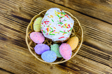 Traditional easter bread and easter eggs made of styrofoam on a wooden background. Top view