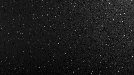 Fototapeta premium A unique black surface scattered with fine specks adding an intriguing and luxurious feel to contemporary design applications