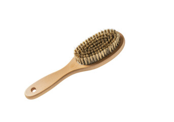 A floating wooden brush with stiff bristles  on a solid white background