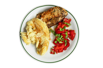 A freshly cooked dish served on a white platter, fried chicken breast with mashed potatoes and red peppers in oil and fresh chopped basil on a white insulated background.