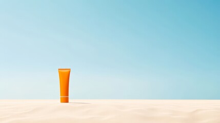 A vibrant orange tube of sunscreen stands alone on soft sandy beach, illuminated by sunlight under a clear blue sky, ready for summer fun and protection